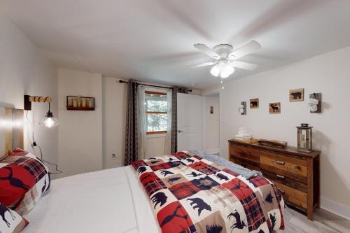 a bedroom with a bed and a ceiling fan at Magic Birch Lodge in Windham