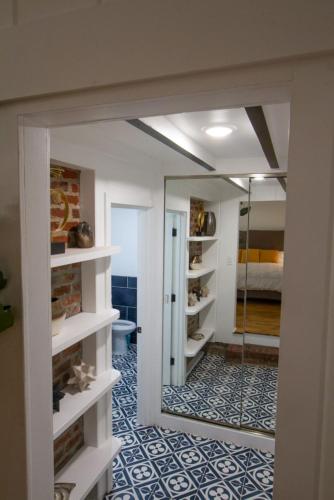 a room with a mirror and a room with a bedroom at Dreamy Farmhouse in Studio City in Los Angeles