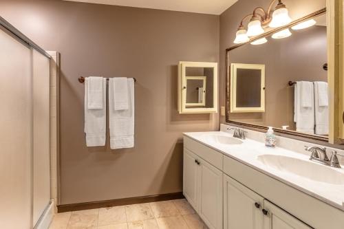 a bathroom with two sinks and a large mirror at Eagles Nest in Bryson City