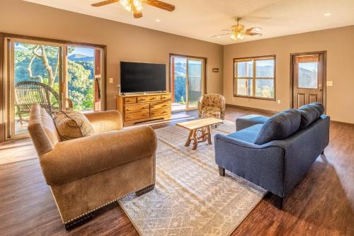 a living room with two couches and a flat screen tv at Eagles Nest in Bryson City