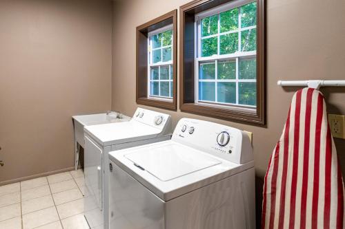 a laundry room with a washer and dryer and a window at Eagles Nest in Bryson City