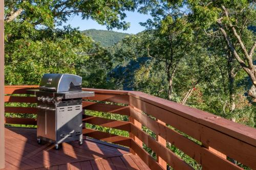 a grill on a deck with a view of the mountains at Eagles Nest in Bryson City