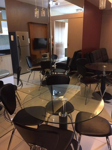 a conference room with tables and chairs and a television at Wind and Sea at Wind Residences in Tagaytay