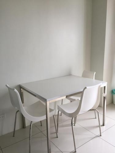 a white table and chairs in a room at Wind and Sea at Wind Residences in Tagaytay