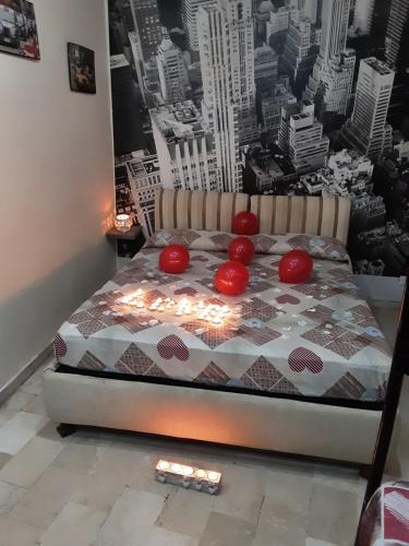 a bed with red tomatoes on it in a bedroom at Affittacamere da chris in Reggio Calabria