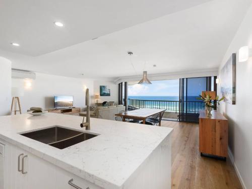 a kitchen and living room with a view of the ocean at The Rocks Resort Unit 8G in Gold Coast