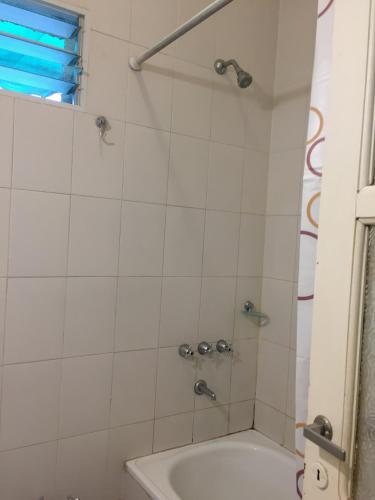 a bathroom with a shower with a tub and a sink at CASA HORTENSIA in Salta