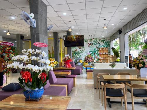 a store with tables and chairs and a vase of flowers at Homestay SALA in Quy Nhon