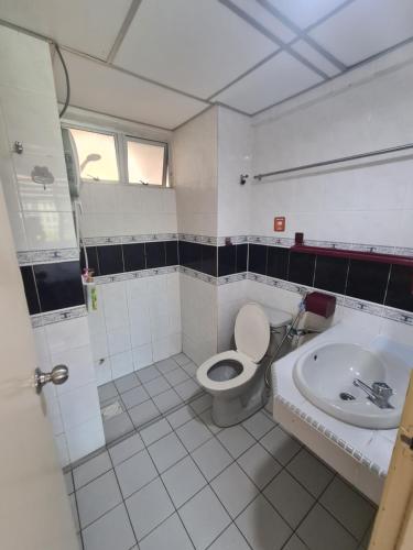 a bathroom with a toilet and a sink at Glory Beach Resort Seaview Private 2BR in Port Dickson
