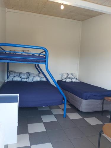 two bunk beds in a room with a tiled floor at Charleston Holiday Park in Charleston