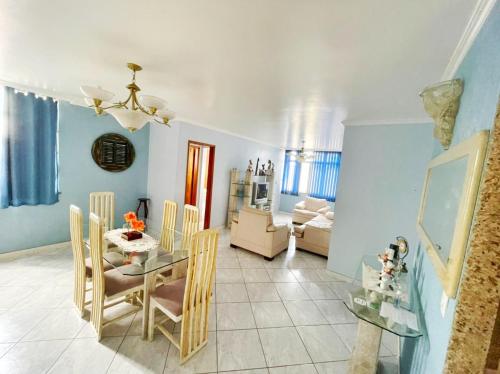 a dining room with a glass table and chairs at Apart 4 quartos Praia do Forte e Canal in Cabo Frio