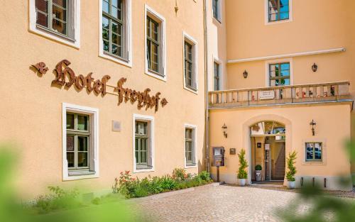 a facade of a building with a balcony at Hotel Freyhof in Freiberg