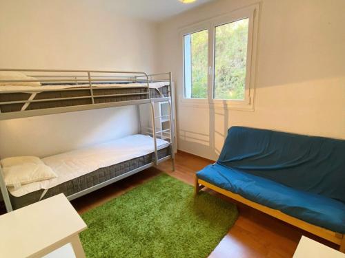 a room with bunk beds and a couch and a window at Appartement Les Deux Alpes, 3 pièces, 6 personnes - FR-1-516-86 in Les Deux Alpes