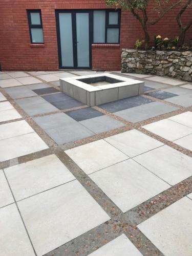 a stone patio with a fountain in front of a building at Dolphin View in Herolds Bay