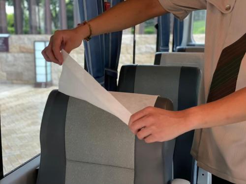 a person holding a piece of paper on a bus at Hotel Royal Chiao Hsi in Jiaoxi