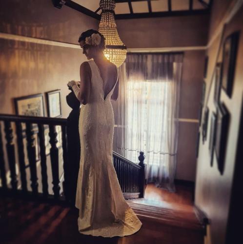 a woman in a wedding dress standing on a staircase at The Great Gatsby Houghton in Johannesburg