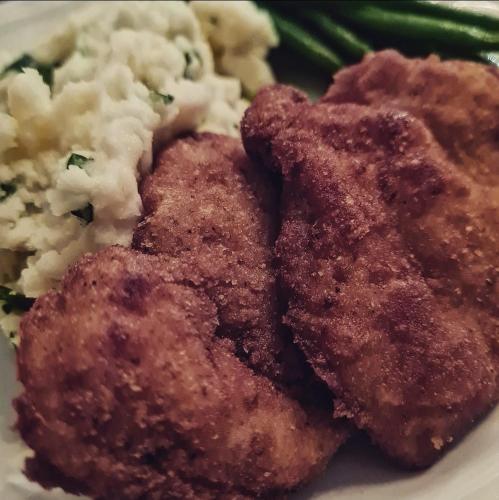 a plate of food with meat and mashed potatoes and green beans at The Great Gatsby Houghton in Johannesburg