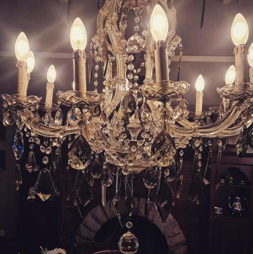 a chandelier with several candles on top of it at The Great Gatsby Houghton in Johannesburg