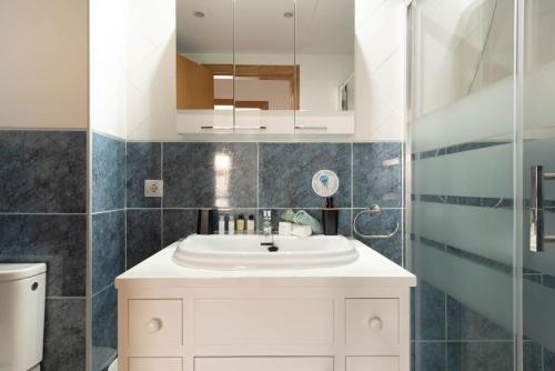 a bathroom with a white sink and a mirror at Aquamarina Beach in Alcudia