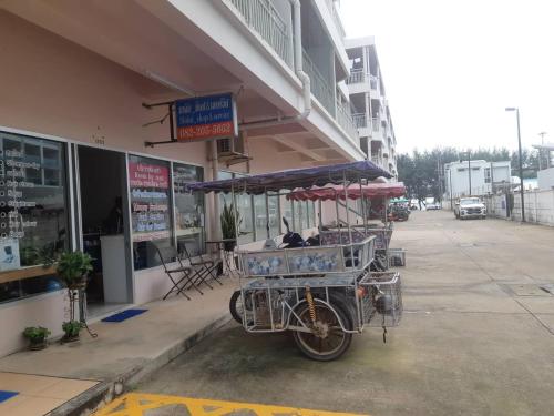 a bike with a cart parked outside of a building at Mosaic Condominium by Malai in Mae Pim