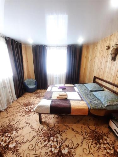 a bedroom with a bed and a window in it at House Baikal in Baykalsk