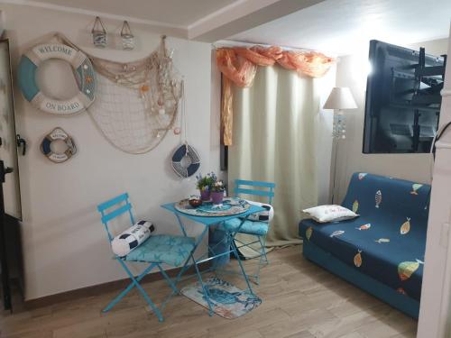 sala de estar con mesa, sillas y sofá en Viky House, en Catania