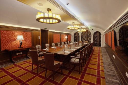 a long dining room with a long table and chairs at Mystery Hotel Budapest, Preferred Hotels & Resorts in Budapest