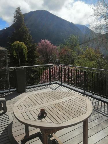 a table on a deck with a view of a mountain at Exklusives Loft "Auszeit für2" in Lofer