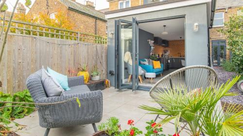 a patio with two chairs and a fence at The Space at 8, garden flat close to town & beach in Whitstable