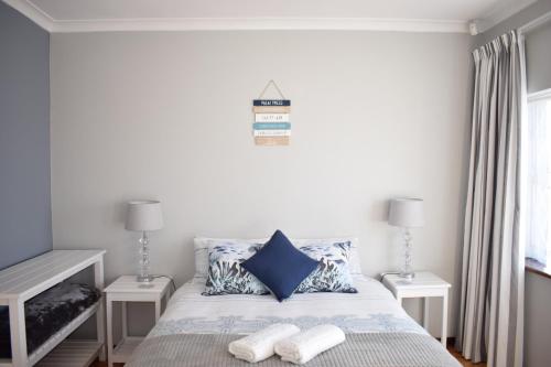 a bedroom with a bed with two night stands at Secure Private Flatlet in Newton Park in Port Elizabeth