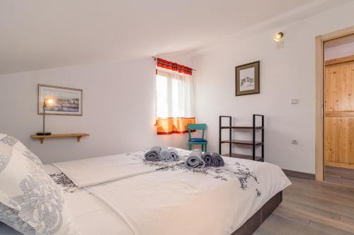 a bedroom with a white bed with towels on it at Villa Nada in Buje