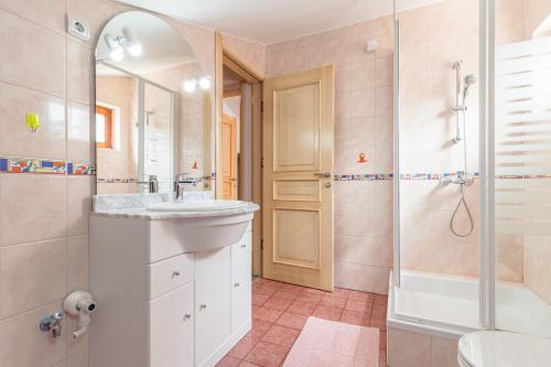 a bathroom with a sink and a shower and a tub at Villa Nada in Buje