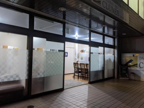 a store front with glass doors and a table and chairs at Ballarat Clunes in Mino