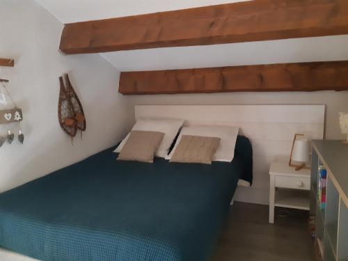 una camera da letto con un grande letto con due cuscini di Chalet CAL CAPOU a Bolquere Pyrenees 2000
