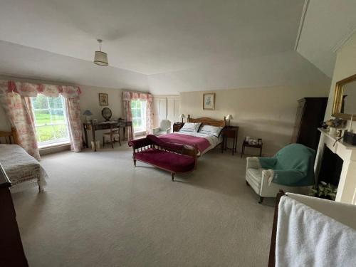 a living room with a bed and a couch at O'Harabrook Country House in Ballymoney