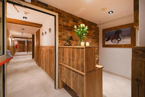 a hallway with wooden walls and a horse painting on the wall at Hotel Mazuria Country & SPA in Mrągowo