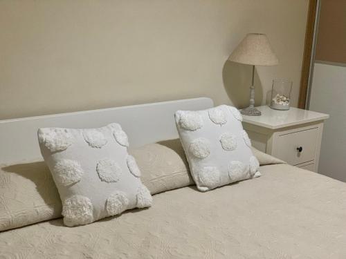 a bed with two white pillows on top of it at Apartamento Playa Ciudad in Santa Cruz de la Palma