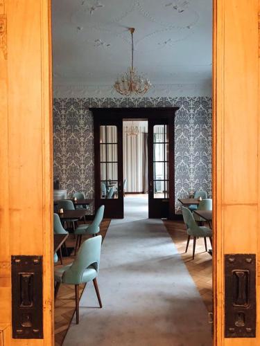 a hallway with chairs and tables in a room at Hotel Dębowy Biowellness & SPA Góry Sowie in Bielawa