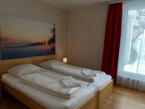 a bed in a bedroom with a painting on the wall at Obertauern Alps in Obertauern