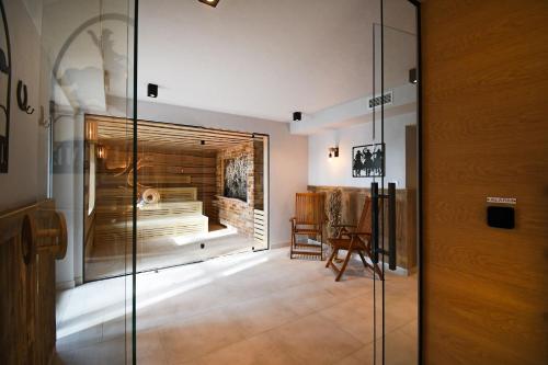 a glass door leading to a room with a fireplace at Hotel Mazuria Country & SPA in Mrągowo