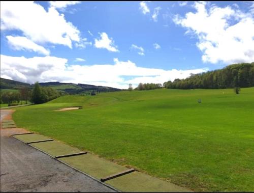a golf course with a green field of grass at Ferienwohnung mit Terrasse für bis zu 4 Personen in Balve
