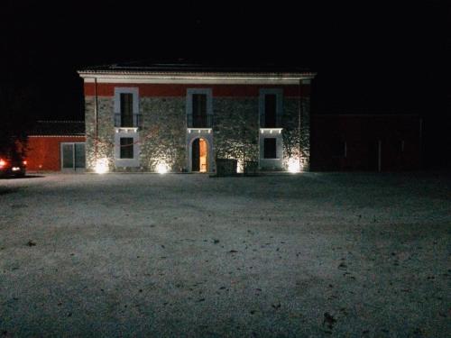 a large building with lights in front of it at night at Agriturismo Dipinto Dal Sole in Padula