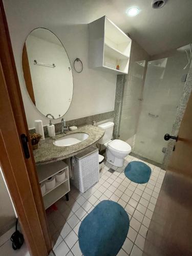 a bathroom with a sink and a toilet and a mirror at Flat Marulhos Resort in Porto De Galinhas