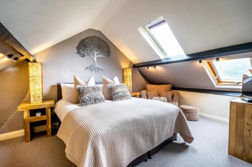 a attic bedroom with a bed and a window at River View, Stamford Bridge in Stamford Bridge