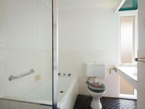 La salle de bains est pourvue de toilettes, d'un lavabo et d'une douche. dans l'établissement Vitamin Sea, à Kiama
