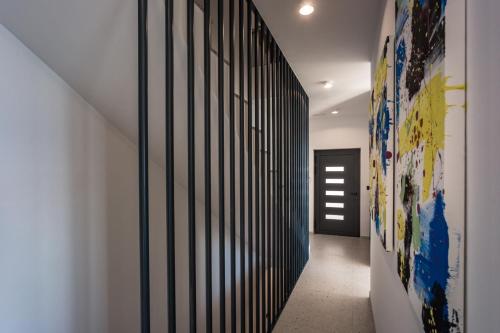 a hallway with black and white vertical lines on the wall at Villa Dispet, sea view, pool, jacuzzi, sauna, cinema in Omiš