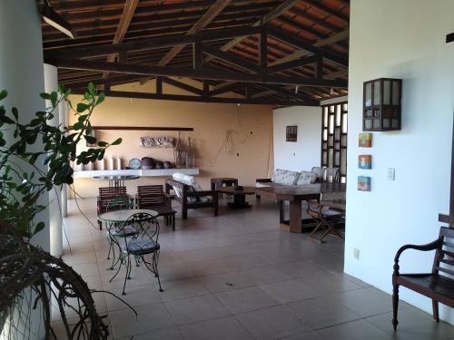 a living room with tables and chairs in a building at Casa de Praia Pecém in São Gonçalo do Amarante