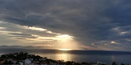 a view of the sun setting over the water at La Bella Suit Otel in Kusadası