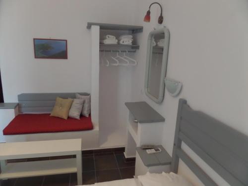 a small room with a bed and a red bench at Skyros Panorama Studios in Skiros