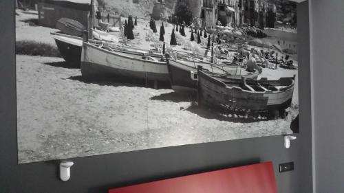 a black and white picture of boats on the ground at Alma Hotel in Palermo